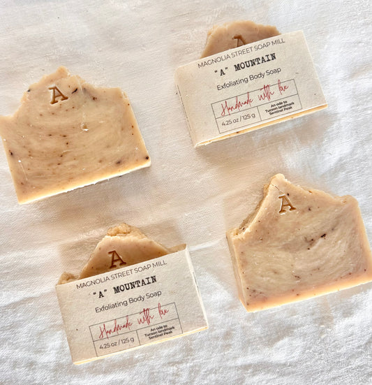 Four A Mountain / Sentinel Peak Bar Soaps on white cloth background.