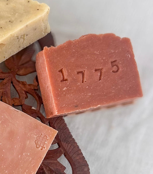 Assorted bars of soap on a textured white surface