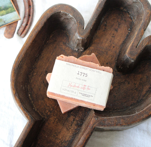 Bar of 1775 handmade soap stacked inside wooden saguaro dough bowl. 